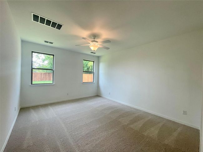 Unfurnished room featuring carpet floors and a ceiling fan | Image 11