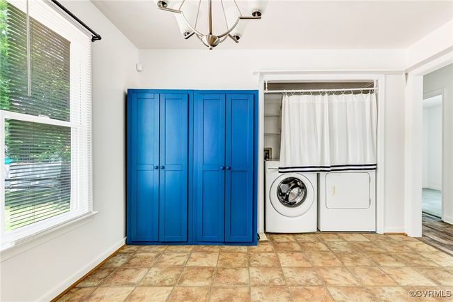 Laundry room with a chandelier, washer hookup, and stone finish floors | Image 27