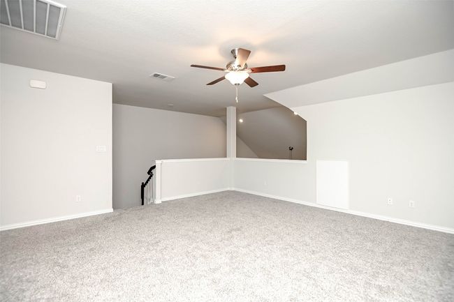Empty room featuring a ceiling fan, carpet floors, baseboards, and visible vents | Image 25