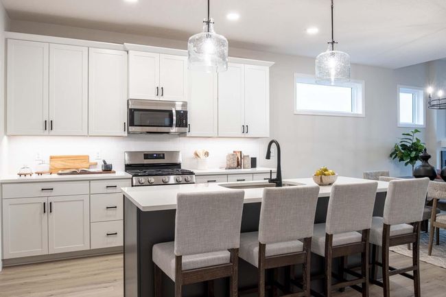 The kitchen is the heart of the home, where function and style come together effortlessly. Spacious and open, it serves as the perfect gathering place for family and friends. Photos are from a previously built home; options and features will vary. | Image 5