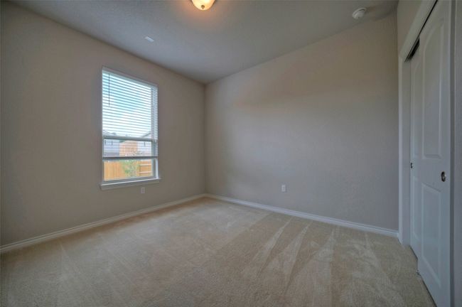 Unfurnished bedroom featuring baseboards, a closet, and light colored carpet | Image 15