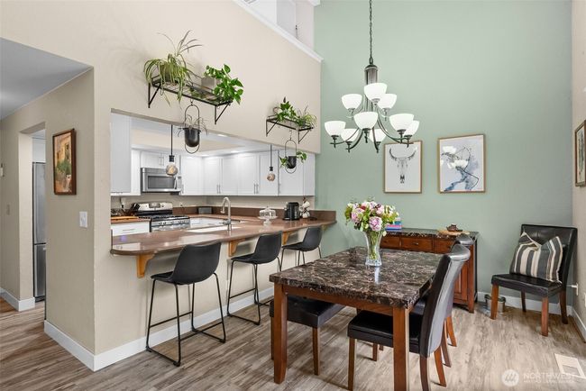 Dining and kitchen area from the living room | Image 10