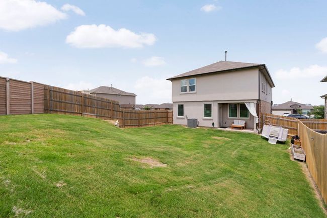 Back of house with a fenced backyard, stucco siding, and a patio area | Image 29