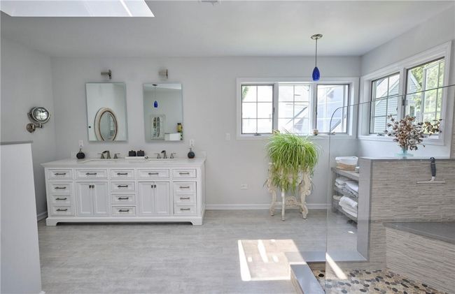 Bathroom with a shower, a skylight, and vanity | Image 27
