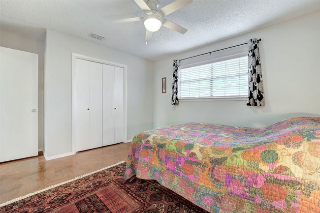 Bedroom with a closet, a textured ceiling, and ceiling fan | Image 19