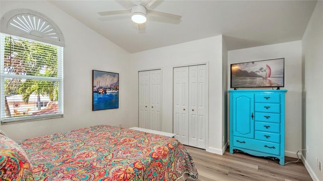 Guest Bedroom upstairs featuring light wood-style floors, multiple closets, lofted ceiling, and a ceiling fan | Image 28