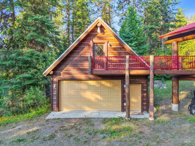 View of front of home featuring a detached garage and a deck | Image 19