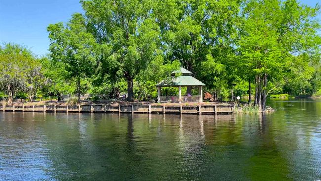 Dock with a gazebo, a water view, and view of scattered trees | Image 32