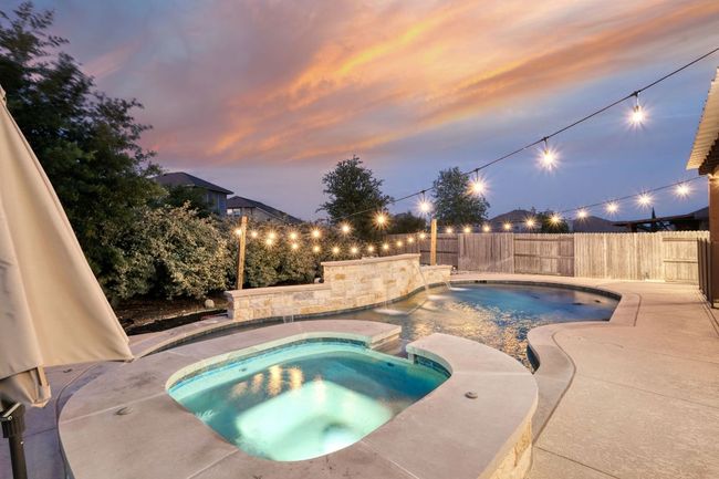 View of pool and hot tub at twilight | Image 27