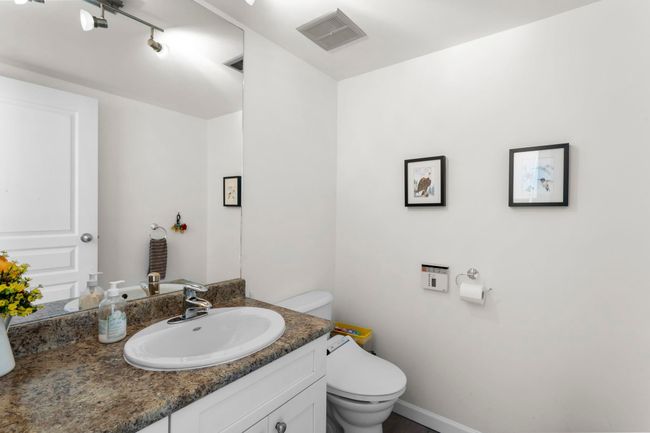 Half bathroom featuring vanity and track lighting | Image 31