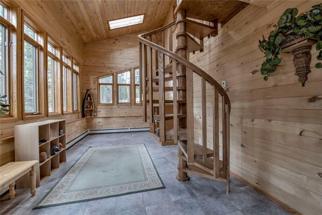 Stairs with wood walls, vaulted ceiling, wood ceiling, and a skylight | Image 24