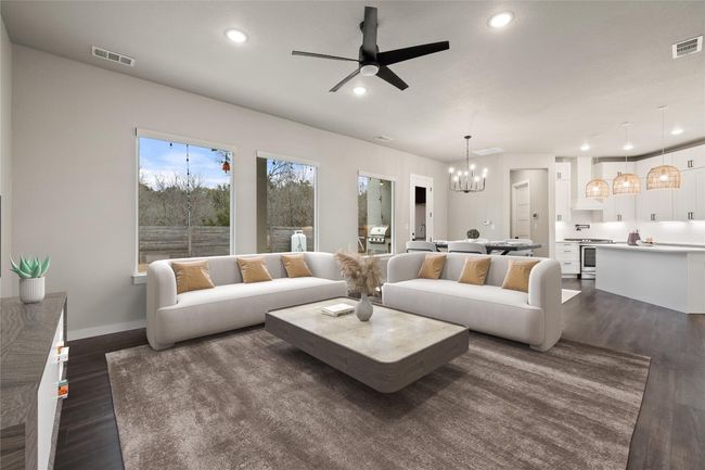 Living area with a ceiling fan, a chandelier, dark wood-style flooring, recessed lighting, and baseboards | Image 18