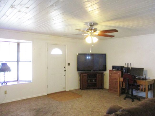 Living area with a ceiling fan, a wealth of natural light, and light carpet | Image 5