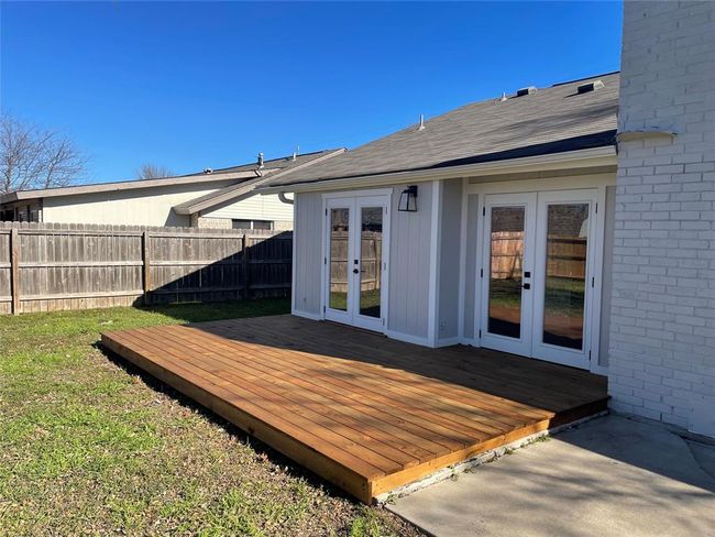 Wooden terrace with french doors and a fenced backyard | Image 19