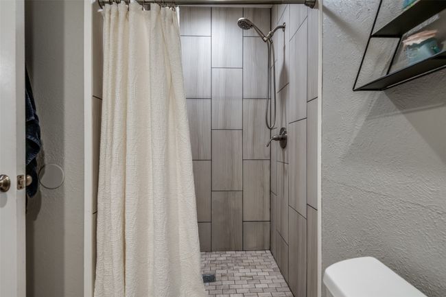 Full bath featuring a textured wall, and beautiful walk in shower. | Image 17