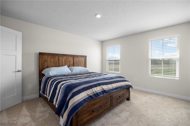 Bedroom featuring light carpet and baseboards | Image 23