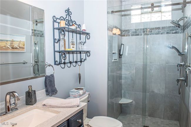 Full bathroom with toilet, a stall shower, and vanity | Image 14