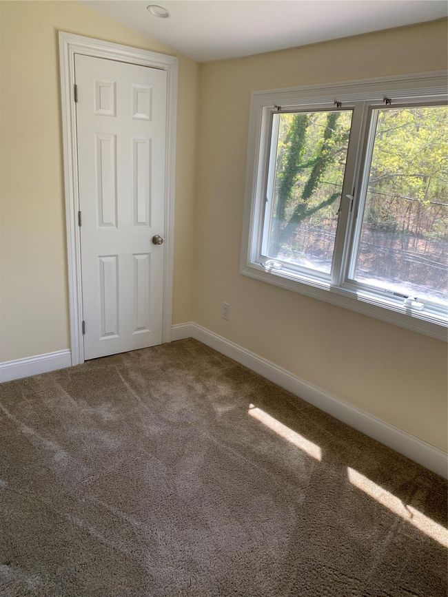 Spare room with freshly shampooed carpet throughout and custom blinds | Image 10