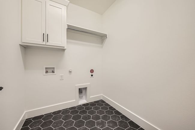 Laundry room with hookup for a gas dryer, hookup for a washing machine, baseboards, and dark tile patterned floors | Image 26