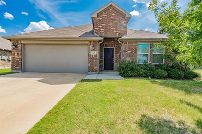 View of front of property with a front yard and a garage | Image 1