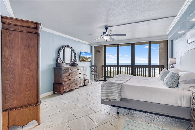 Master bedroom with a wall of windows. | Image 15