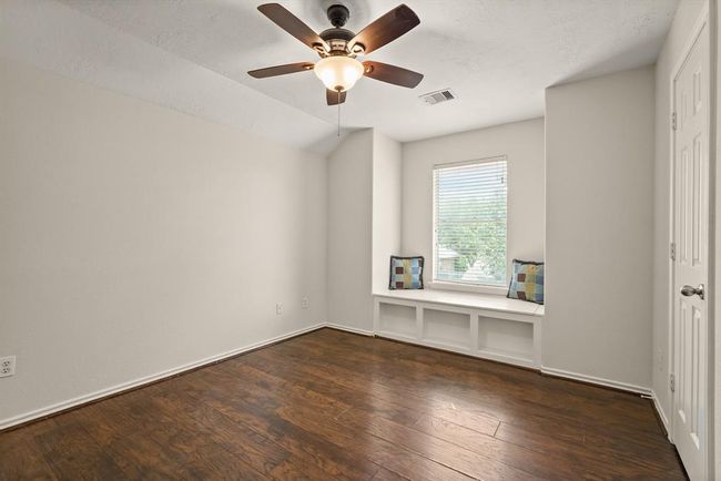 Upstairs bedroom 3 featuring a built-in storage bench and charming reading nook. | Image 19