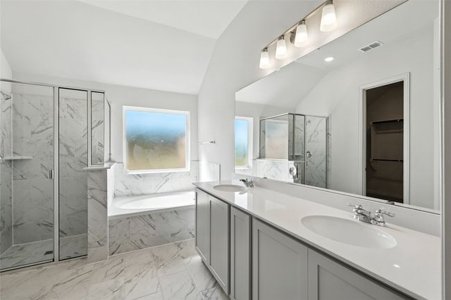 Full bath featuring a marble finish shower, a garden tub, marble finish flooring, double vanity, and lofted ceiling | Image 22