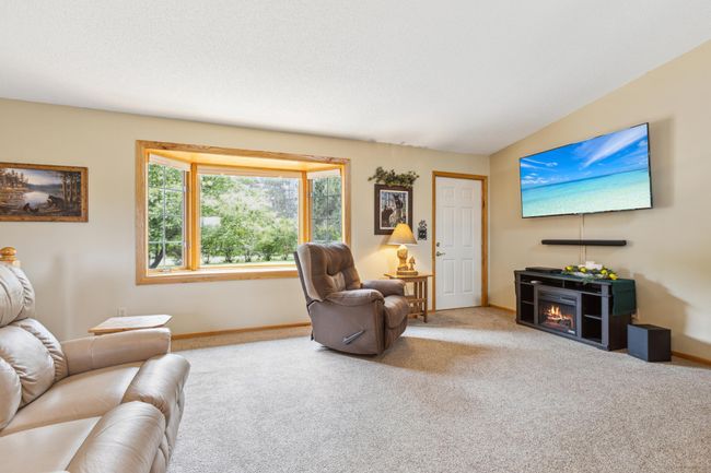 Natural light streams in the large bay window and shows off picture perfect views of the front yard. | Image 11