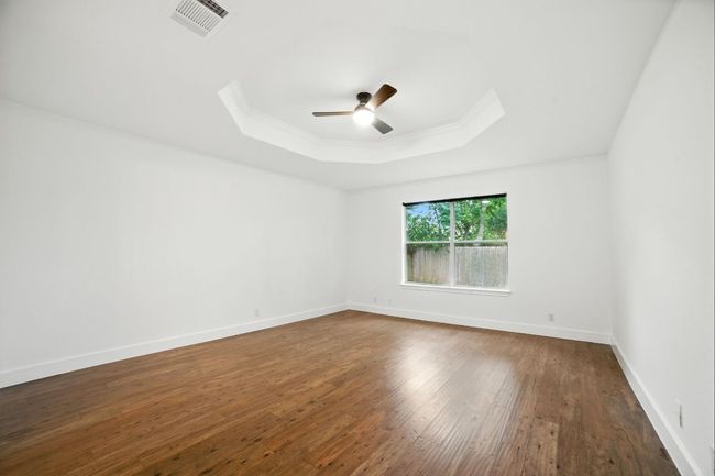 The smart floor plan includes a private primary suite tucked away at the back of the home. | Image 15