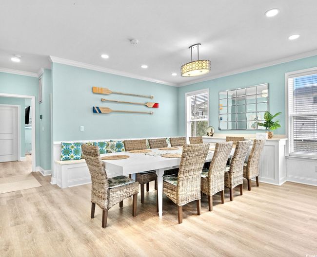 Dining room featuring crown molding, light wood-type flooring, plenty of natural light, and recessed lighting | Image 10