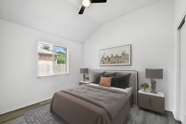 Bedroom with vaulted ceiling, dark wood finished floors, and ceiling fan | Image 23