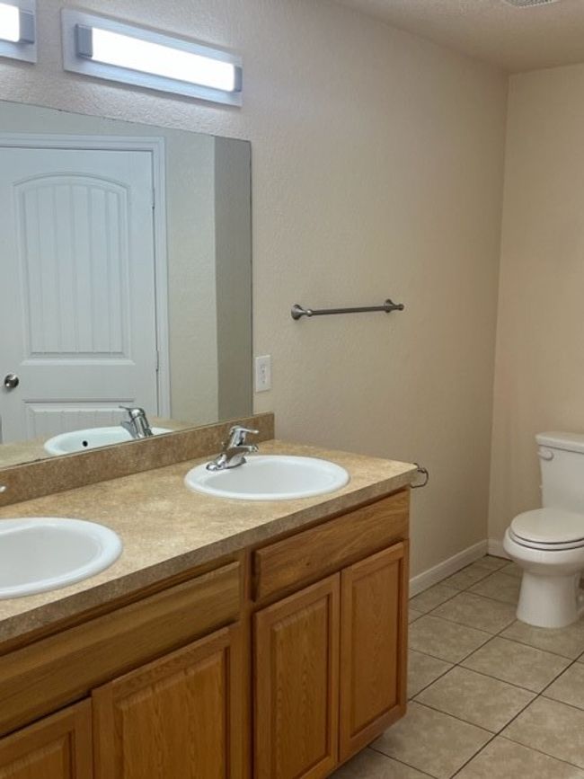 Bathroom featuring tile patterned flooring, and double vanity. | Image 8