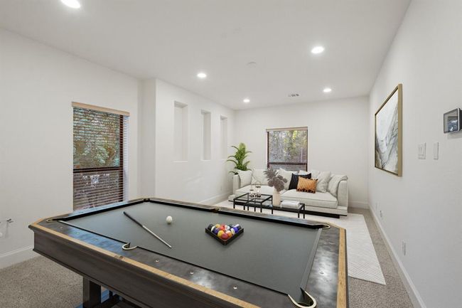Experience the ultimate entertainment oasis, pre-wired for surround sound and ready for a wet bar or additional bathroom, this upstairs gameroom is tailored for your leisure and convenience. This picture is virtually staged. | Image 30