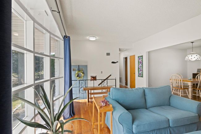 Open living area with large bay window, hardwood floors and bright light | Image 5