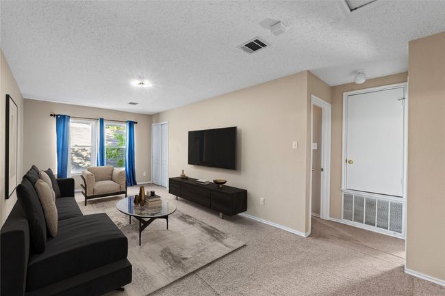 Living area featuring carpet floors, baseboards, and a textured ceiling | Image 15