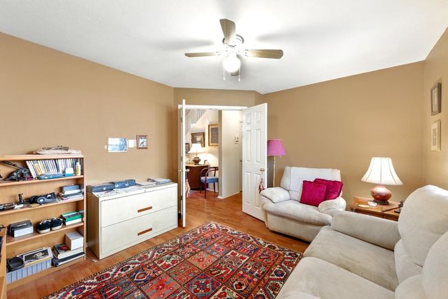 Living room with ceiling fan and light wood-style flooring | Image 23