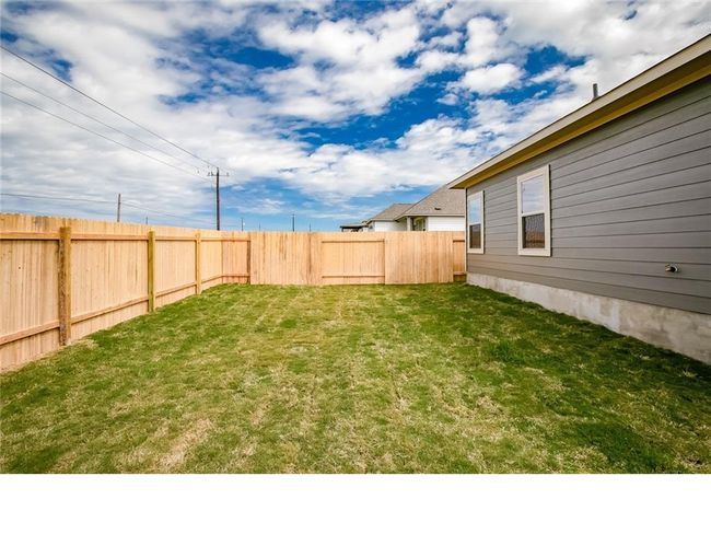 View of fenced backyard | Image 26