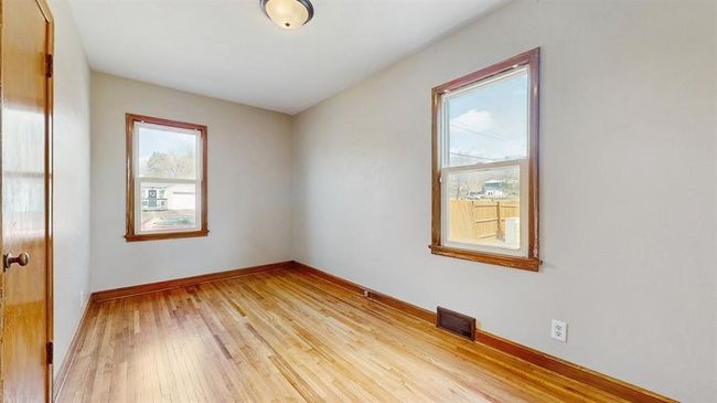 Main level bedroom #1. Refinished hardwood floors and fresh paint. | Image 5