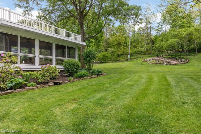 View of yard with a sunroom and a balcony | Image 7