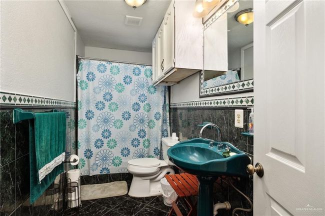 Bathroom featuring tile walls, toilet, tasteful backsplash, and tile patterned flooring | Image 9