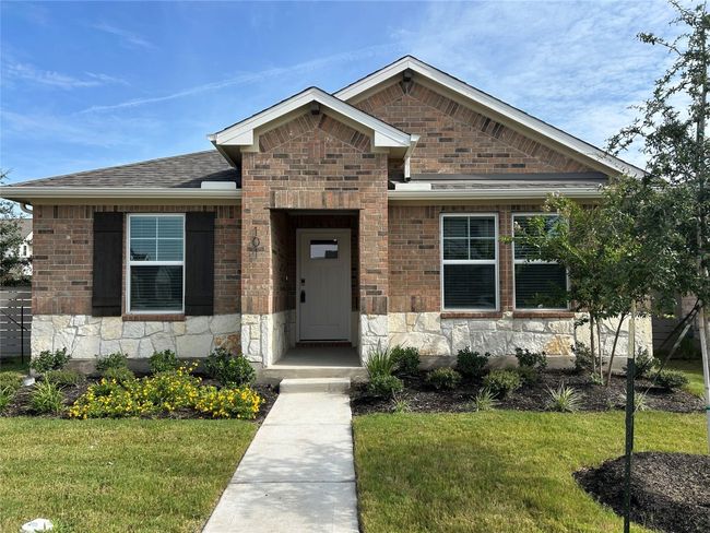 View of front facade featuring a front lawn, roof with shingles, and stone siding | Image 5