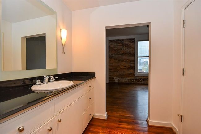 Another view of the primary bathroom, highlighting the sink and mirror from a different angle. This perspective emphasizes the spacious layout. | Image 27