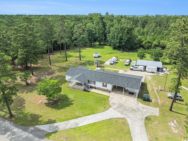 Aerial view of property and surrounding area featuring a forest | Image 31