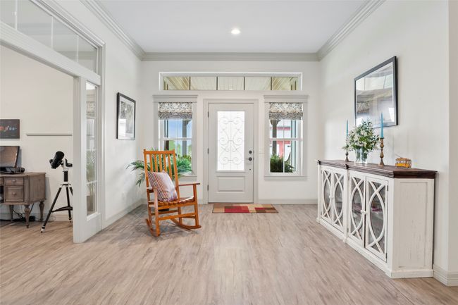 Entryway with baseboards, light wood-type flooring, and crown molding | Image 7