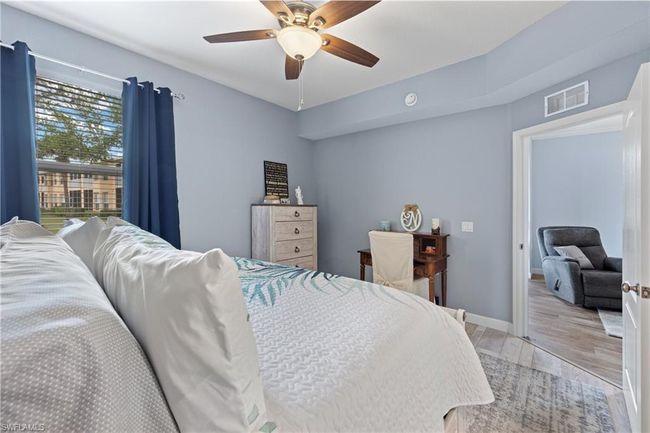 Bedroom with ceiling fan and light lvp / wood-style flooring | Image 15