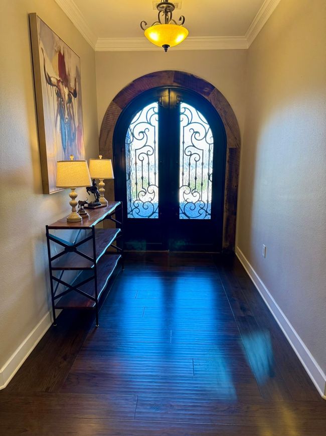 Entrance foyer with french doors, arched walkways, and ornamental molding | Image 6