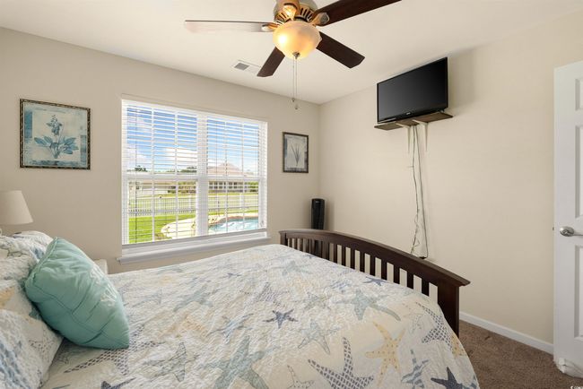Bedroom featuring carpet floors, baseboards, and ceiling fan | Image 14