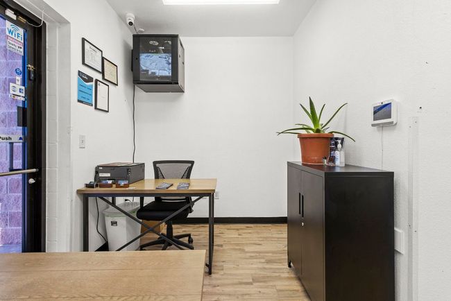 Office space with light wood-style flooring and baseboards | Image 26