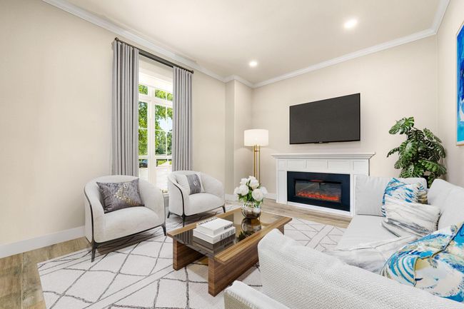 A bright and inviting formal living room nestled at the front of the home featuring neutral paint and fire place with mantel detailing, crown molding, recessed lighting and plenty of natural light to brighten the room. | Image 8