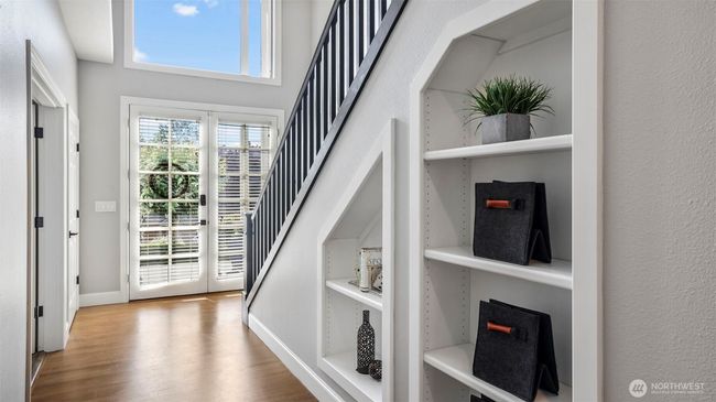 Customizable glass doors with built-in blinds lead you into a bright entryway with rich hardwood flooring. Functional cubbies line the stairs, ideal for showcasing personal touches or keeping essentials organized | Image 4
